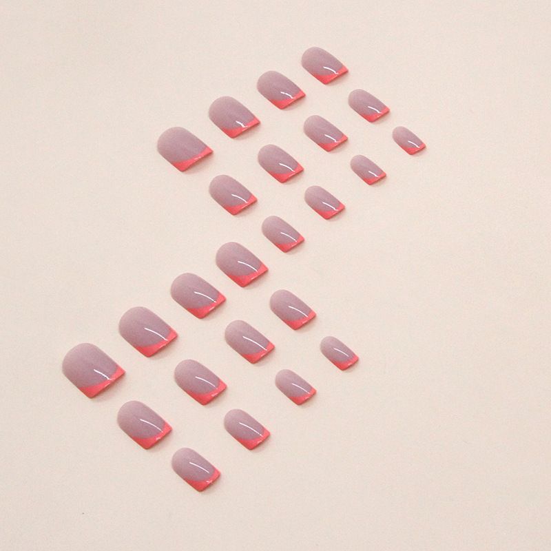 A close up of a person 's nails with a pink and red french manicure.