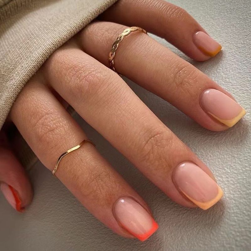 A close up of a woman 's nails with rings on them