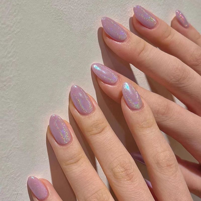 A close up of a person 's nails with purple nail polish.