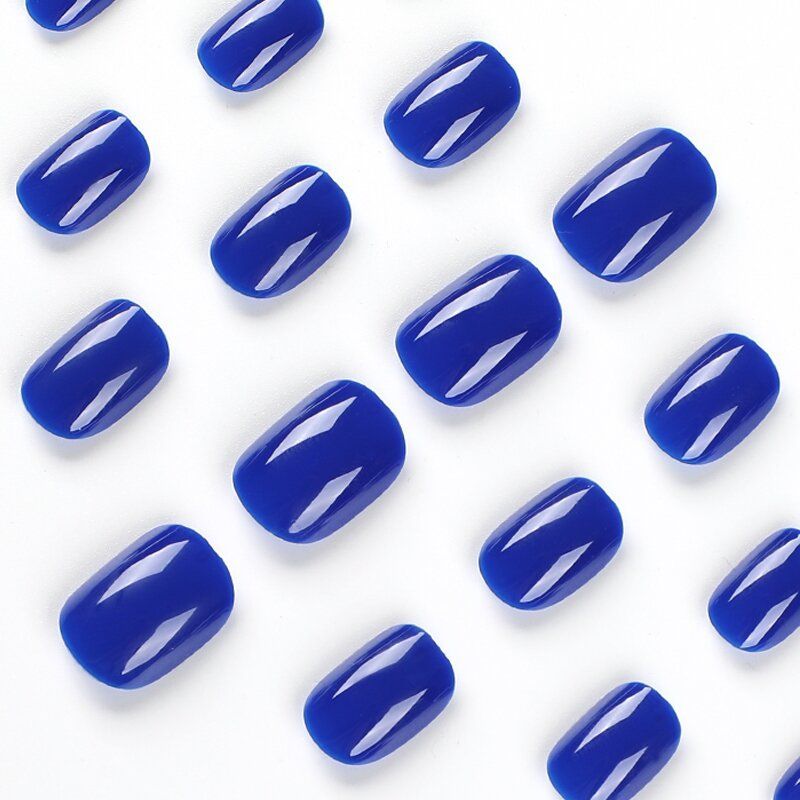 A close up of a person 's hand with blue nails