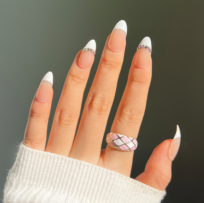 A close up of a woman 's hand with a ring on her finger