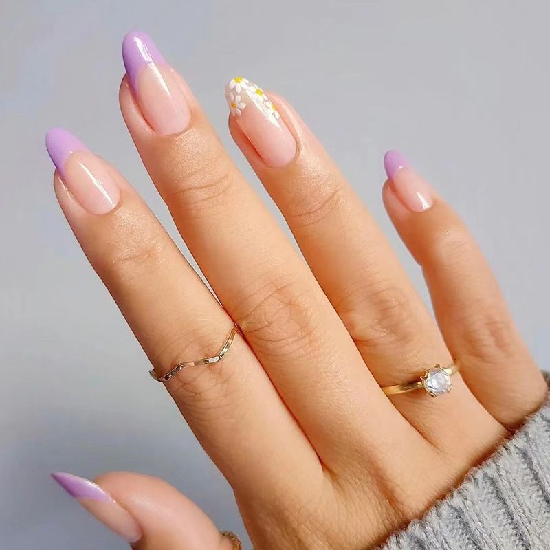 A close up of a woman 's hand with rings on her fingers
