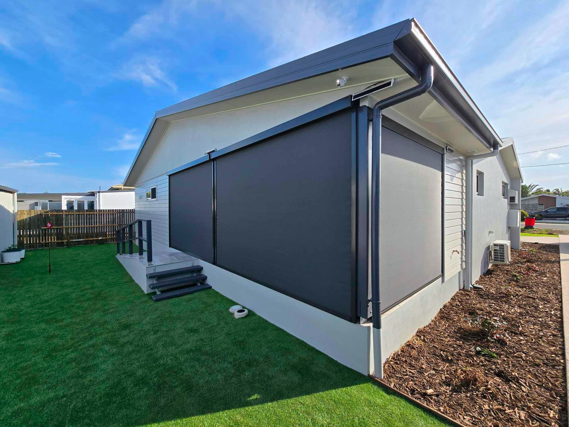 A Brick Building With A Canopy On The Side Of It — Modern Window Furnishings In Bargara, QLD
