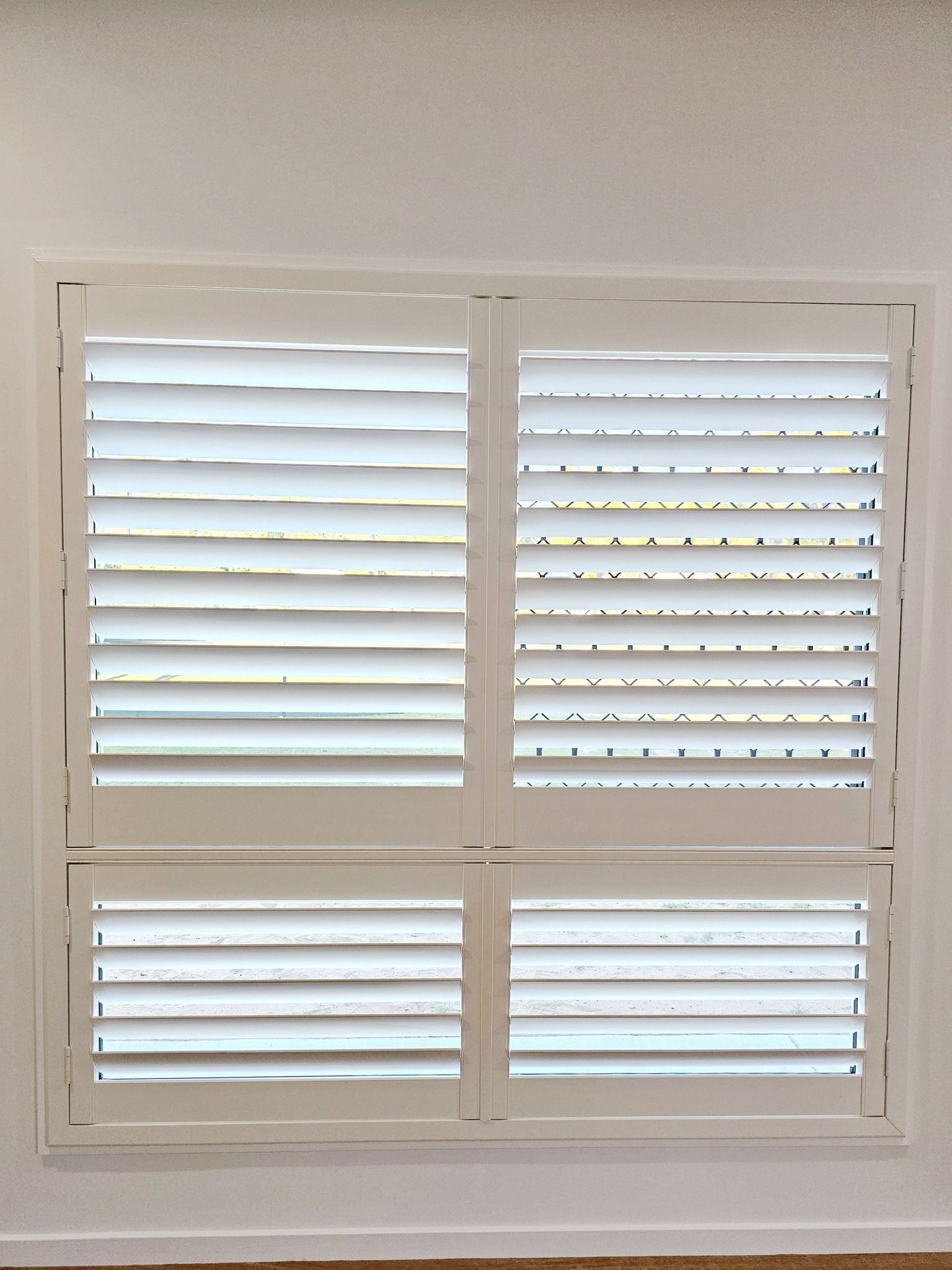 A Bathroom With White Shutters On The Doors And A Mirror — Modern Window Furnishings In Gin Gin, QLD