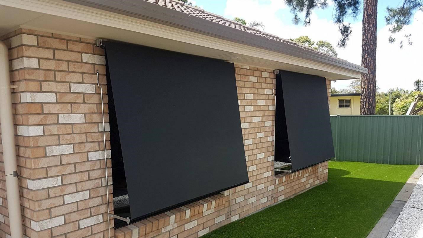 A Canopy With A Clear Glass Roof Is On The Side Of A House — Modern Window Furnishings In Agnes Water, QLD