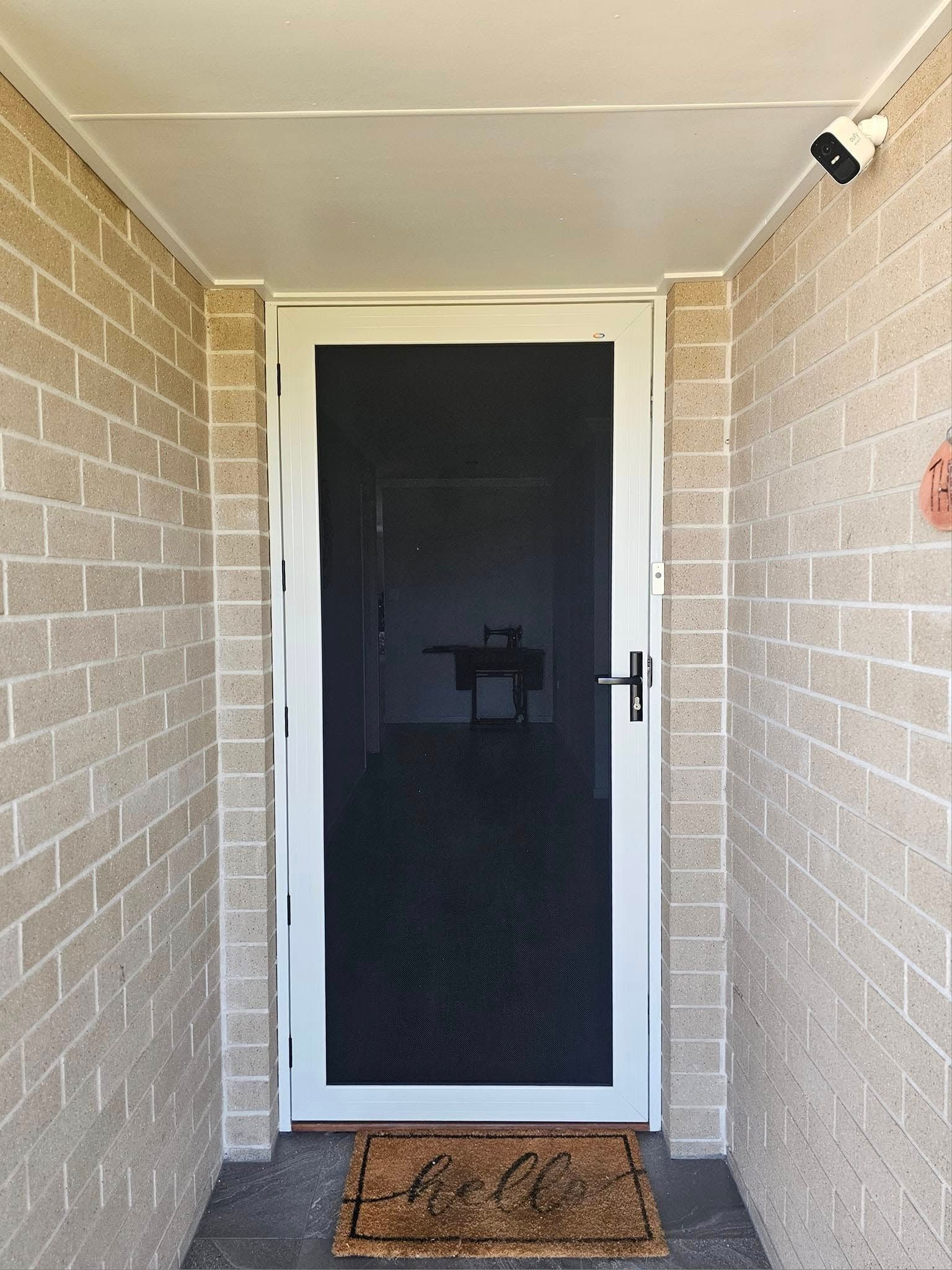 A Wooden Door With A Gray Frame Is Against A White Wall — Modern Window Furnishings In Agnes Water, QLD