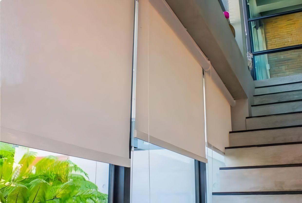 A Window With Roller Blinds And Stairs In The Background — Modern Window Furnishings In Bundaberg East, QLD