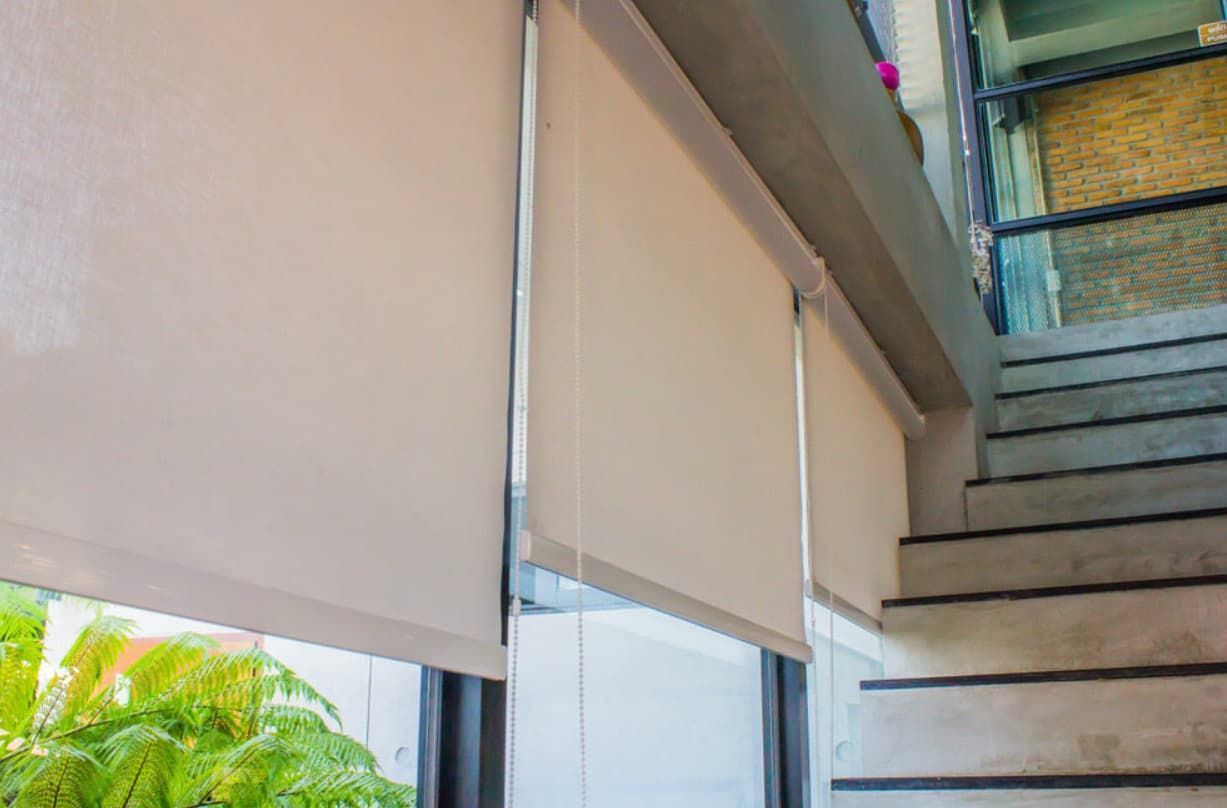 A Window With Roller Blinds And Stairs In The Background — Modern Window Furnishings In South Kolan, QLD