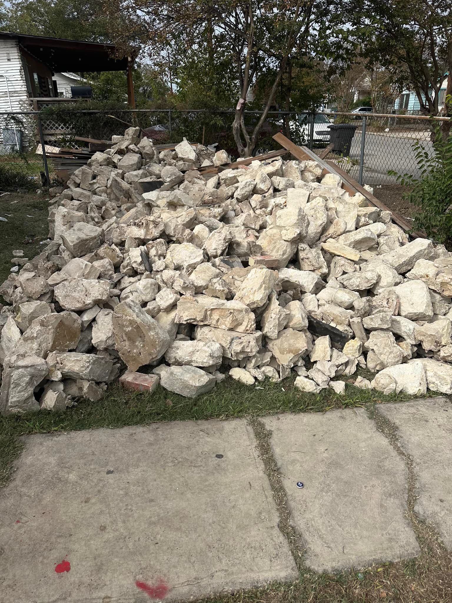 A pile of rocks is sitting on top of a sidewalk.