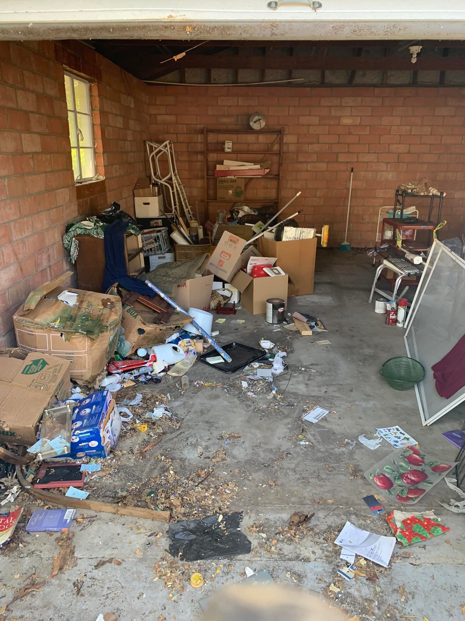 A garage filled with lots of boxes and trash.
