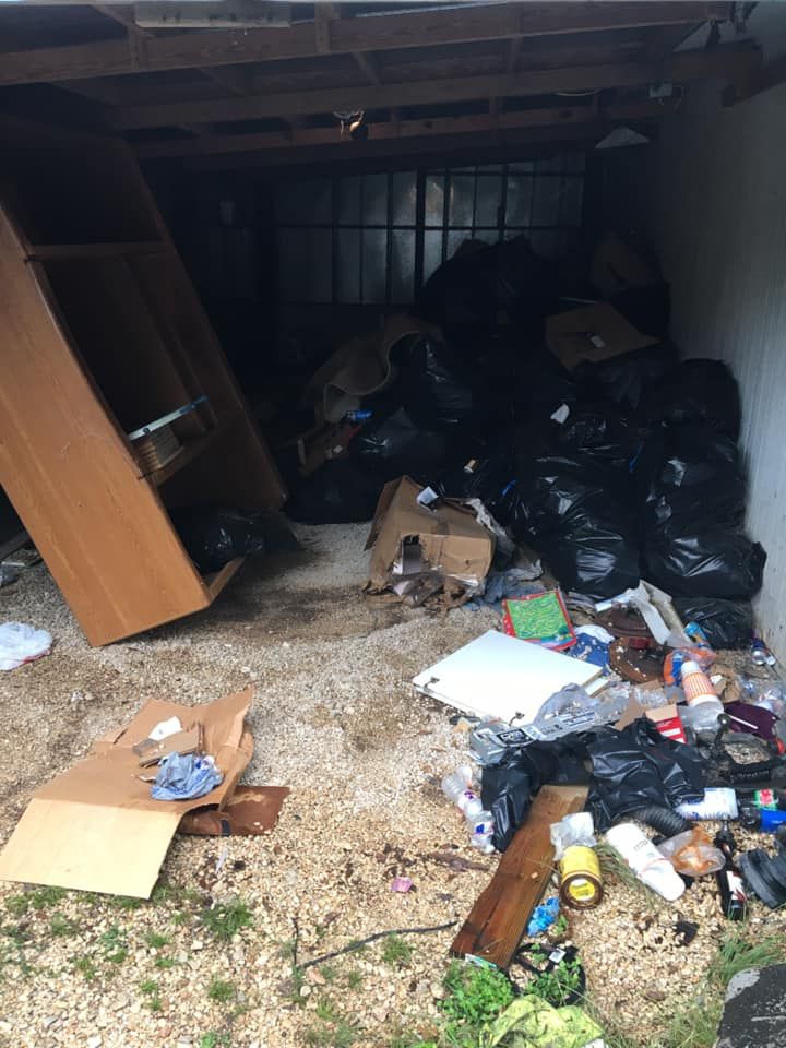 A garage filled with lots of trash and junk.