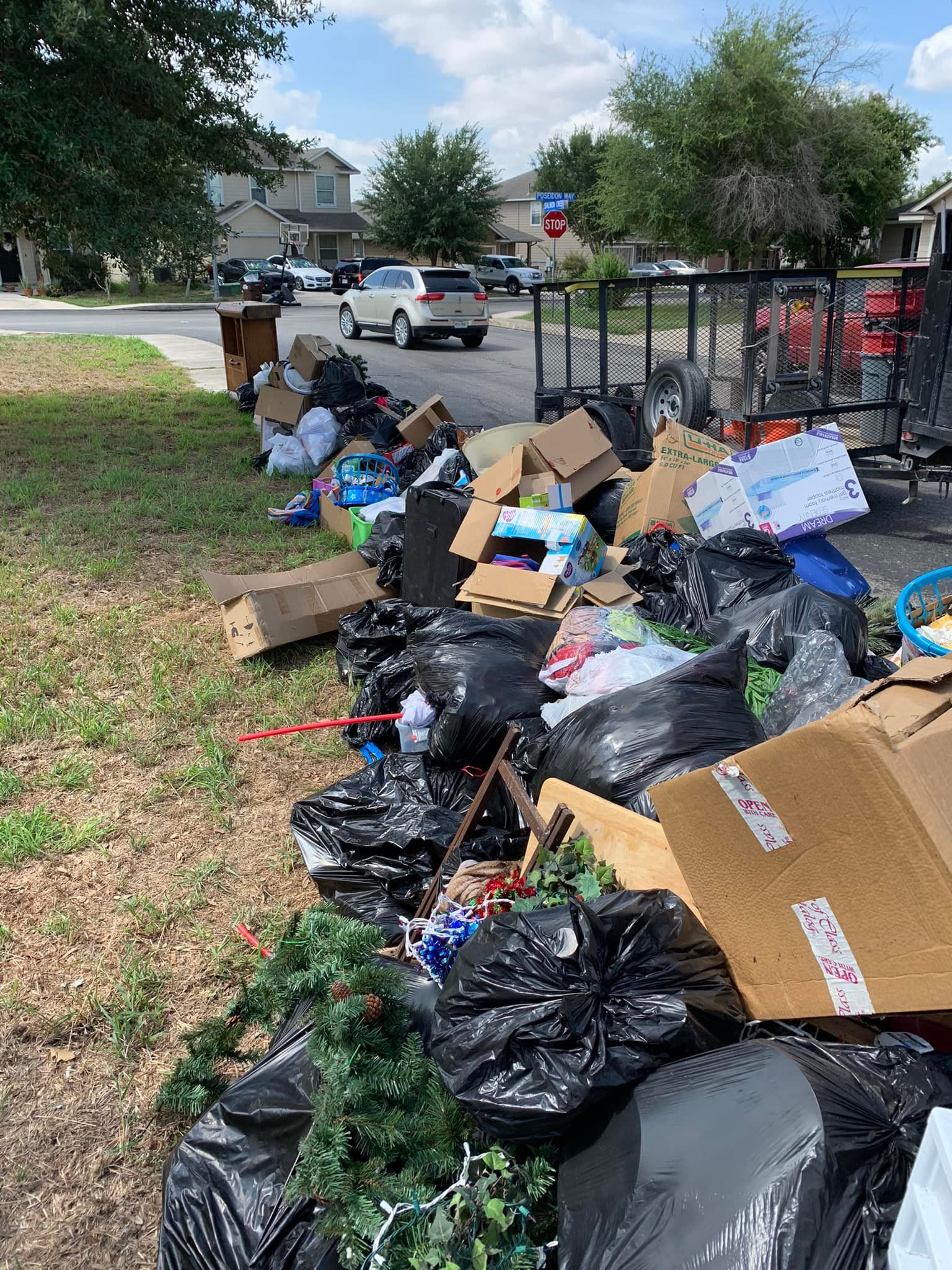 There is a lot of trash on the side of the road.