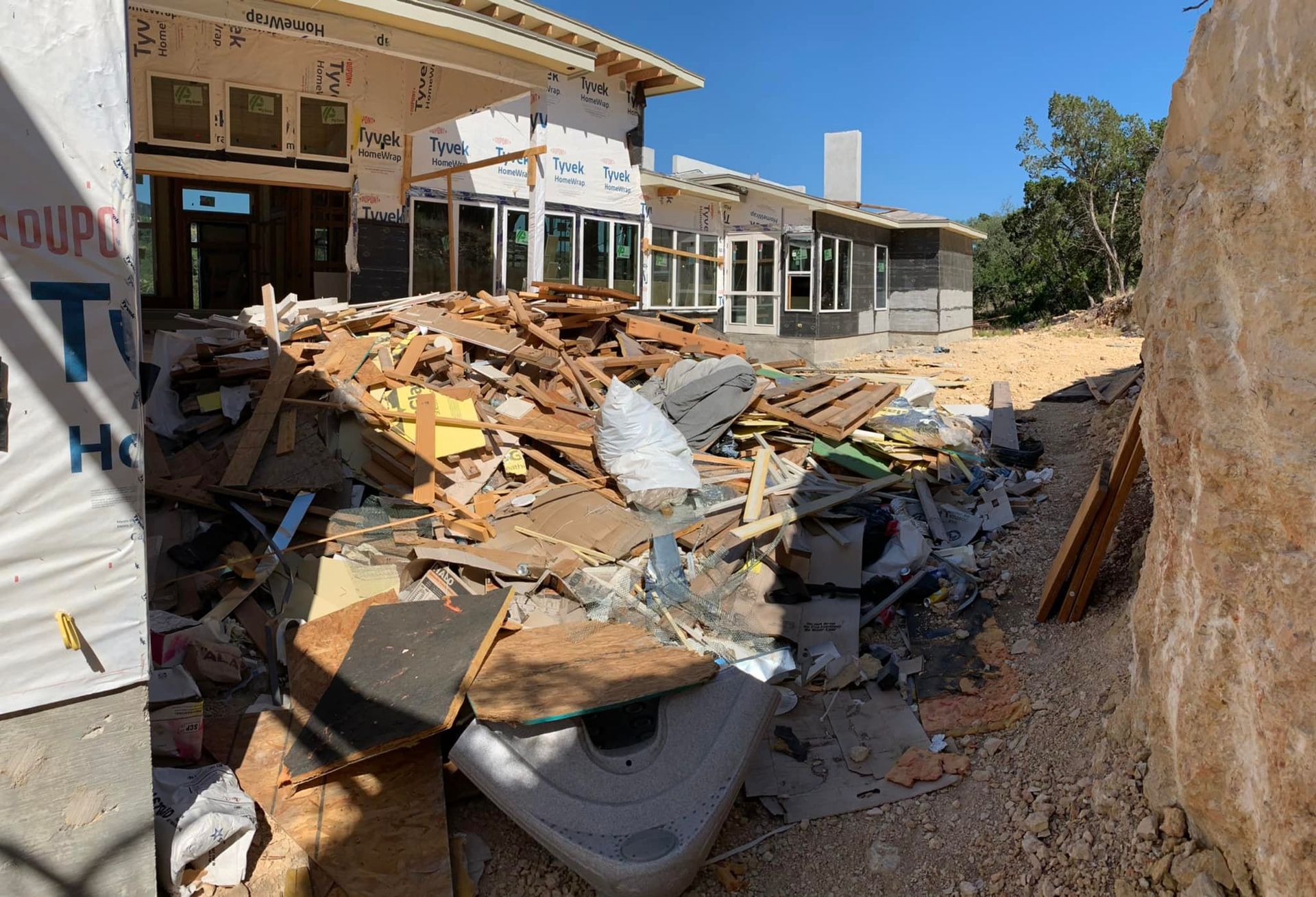 A pile of rubble is sitting in front of a building under construction.