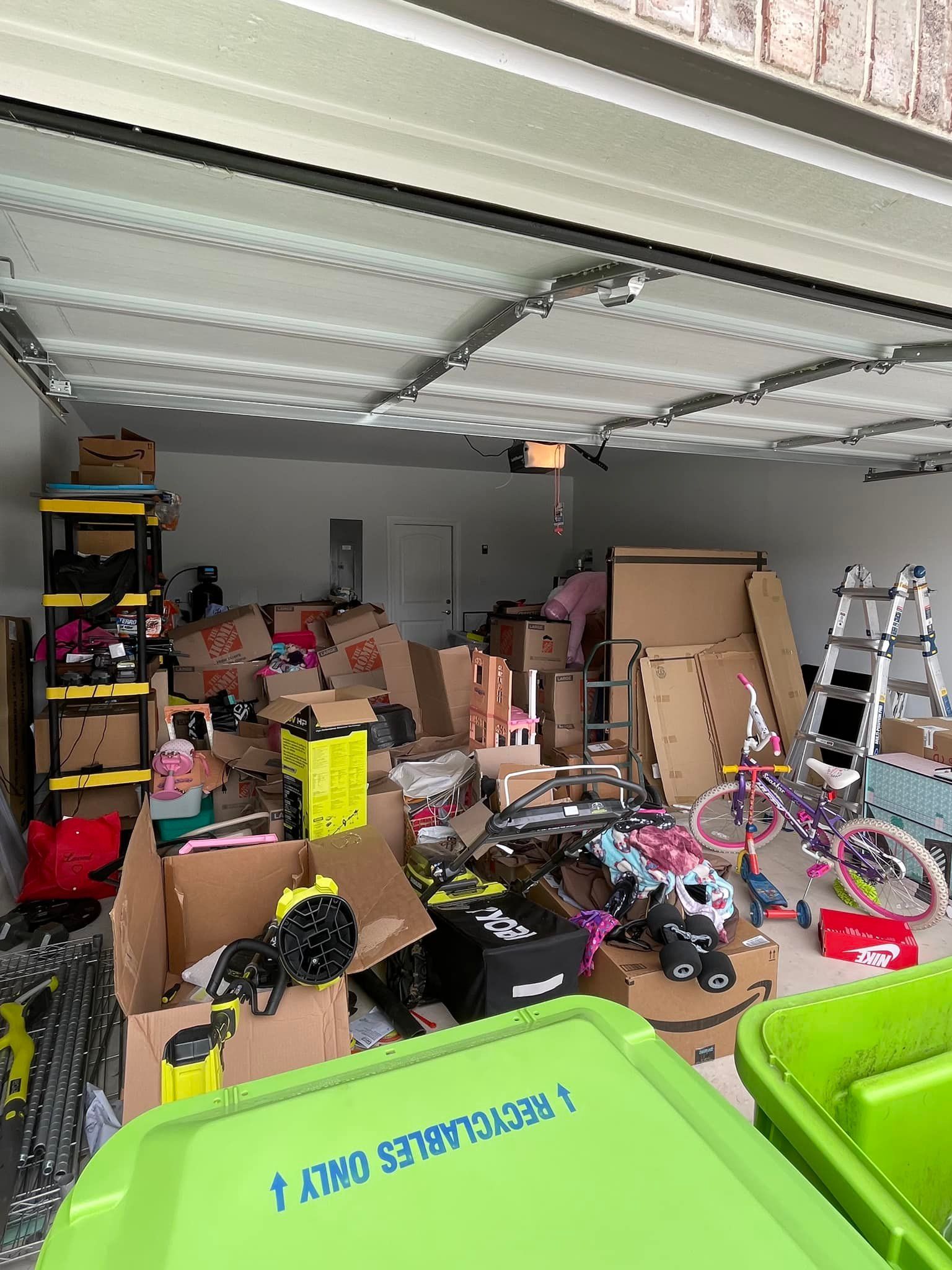 A garage filled with lots of boxes and bicycles.
