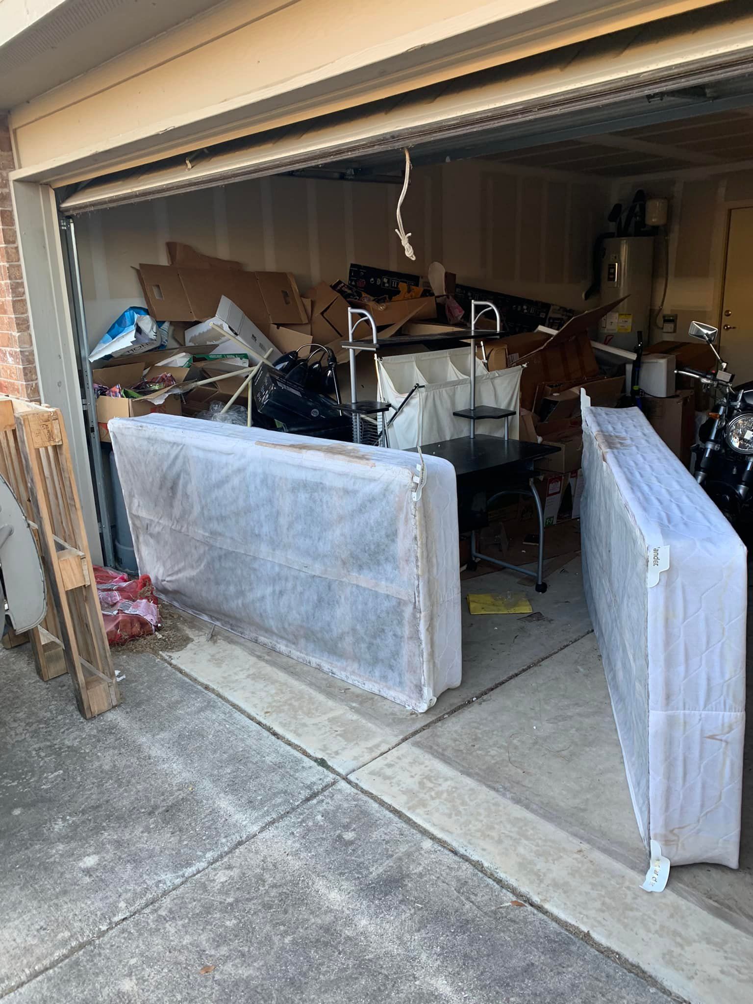 A garage filled with lots of furniture and mattresses.