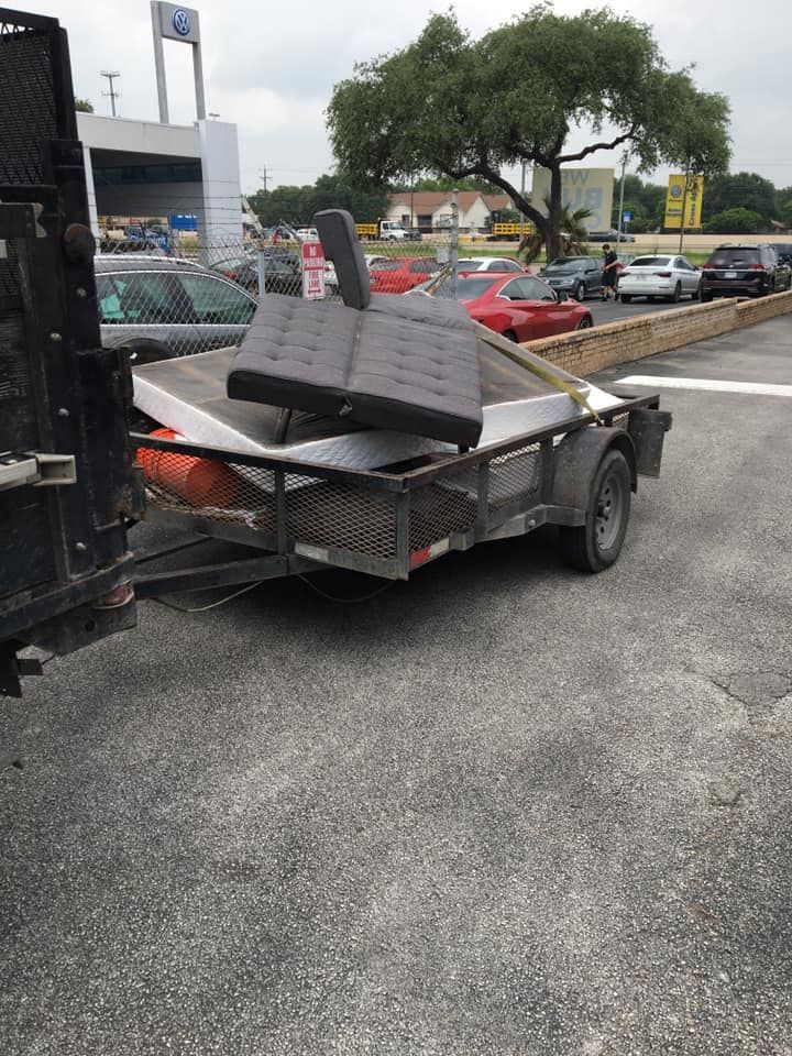 A trailer with a couch on it in a parking lot