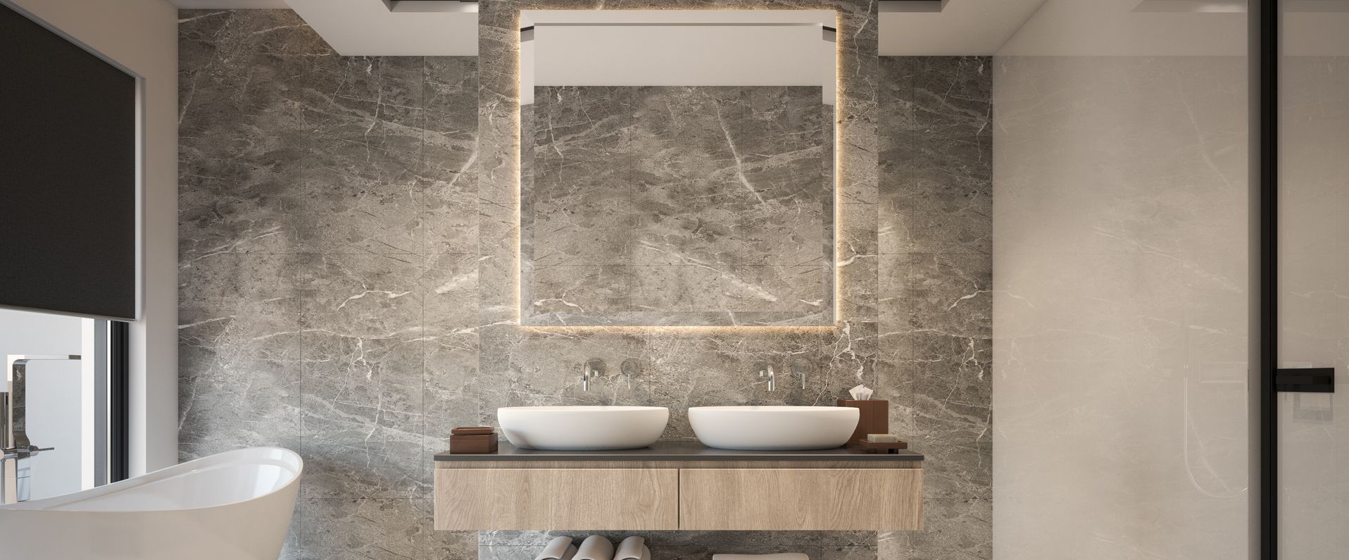 A bathroom with two sinks , a mirror and a tub.
