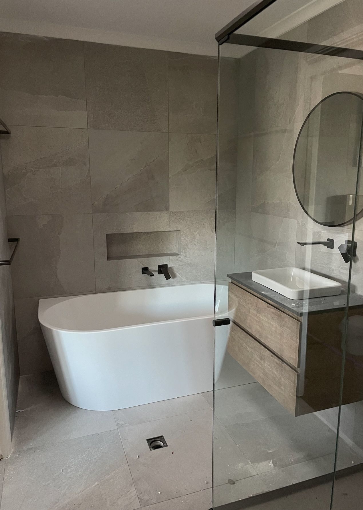 A bathroom with a bathtub , sink , mirror and walk in shower.