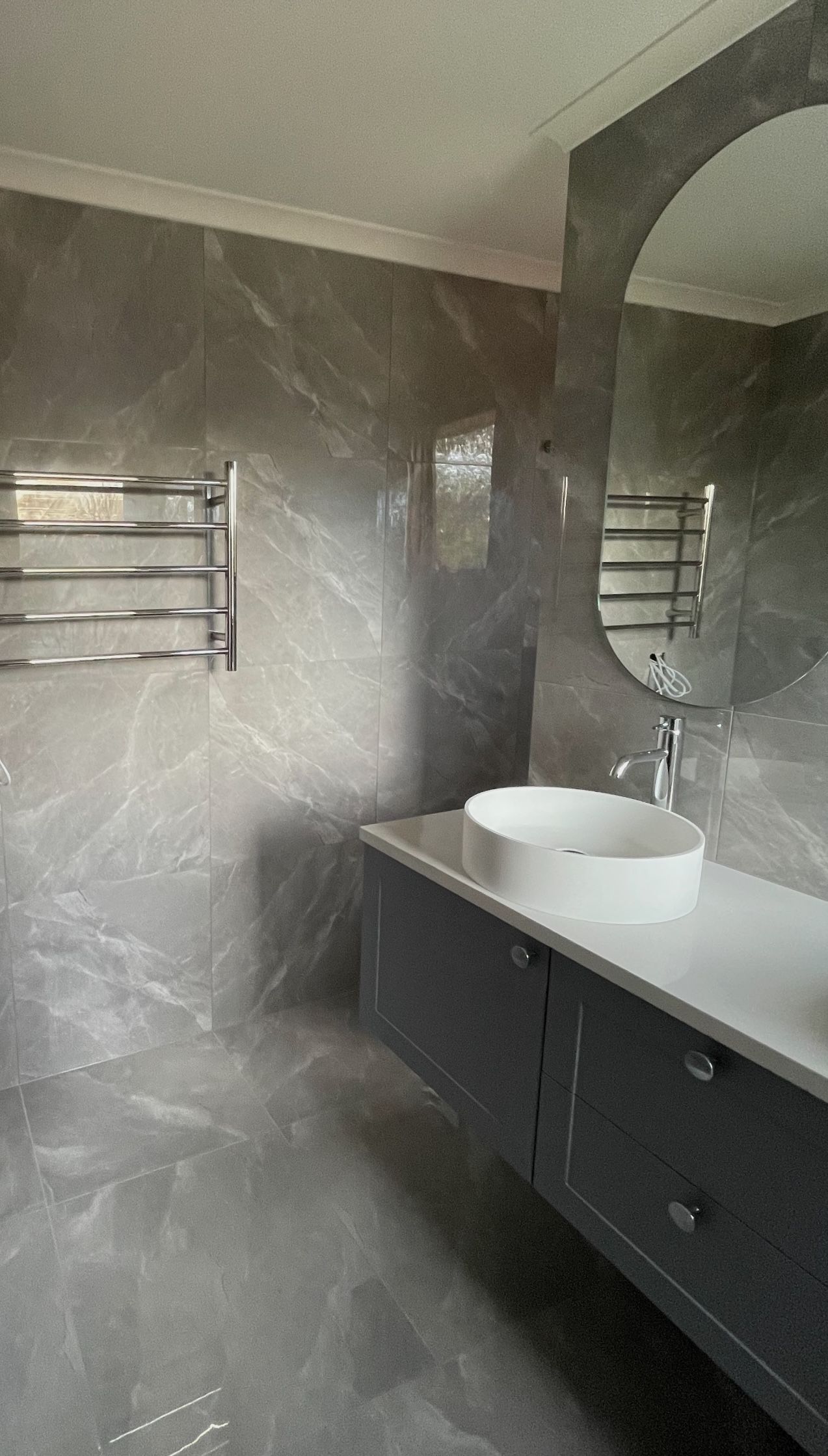 A bathroom with two sinks and a large mirror.
