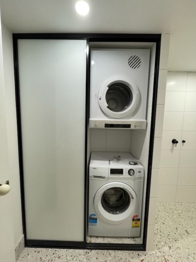 A washer and dryer in renovated laundry