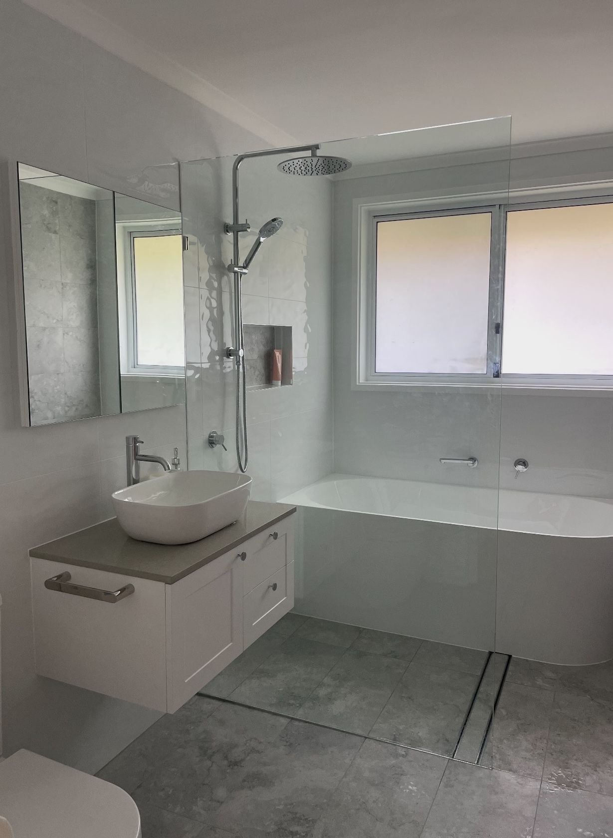 A bathroom with a sink , toilet , bathtub and shower.