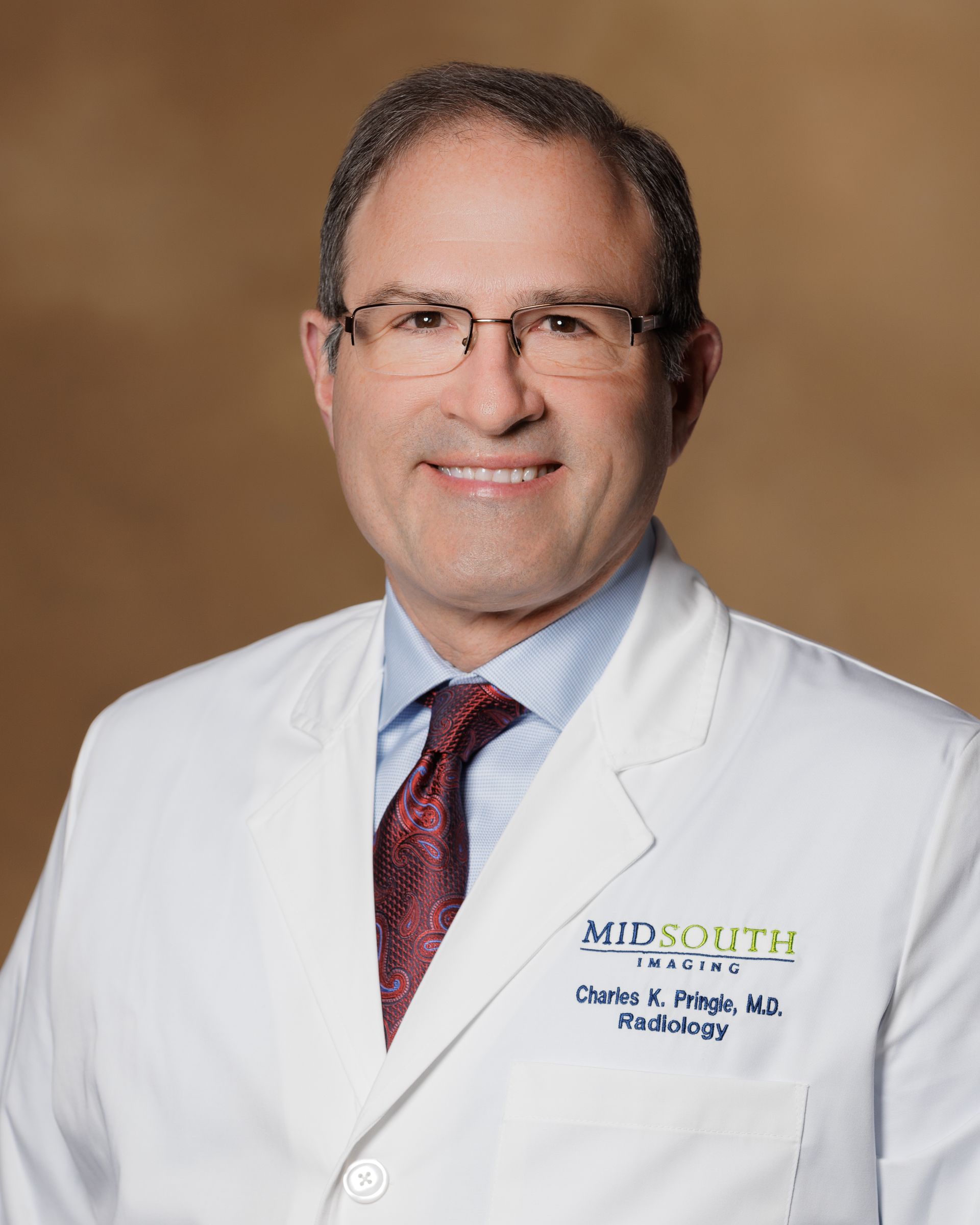 A man wearing a white coat and tie is a doctor