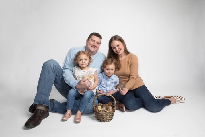 A family is sitting on the floor posing for a picture. — Evanston, IL — Bordeaux Studio