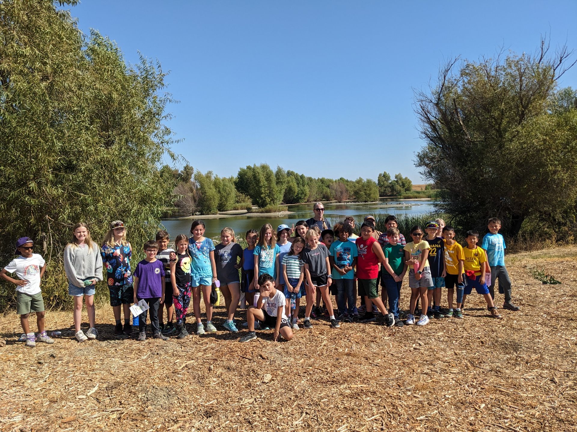 Class photo of 4th graders at the park