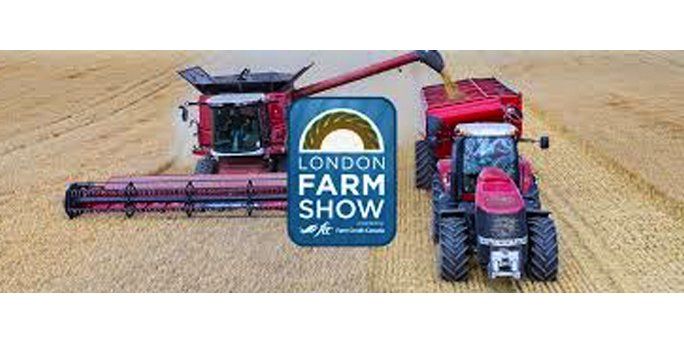 A combine harvester and a tractor are working in a field at the london farm show.