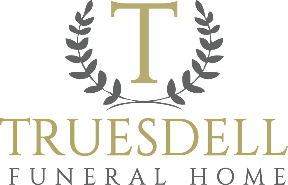The logo for truesdell funeral home has a laurel wreath around the letter t.