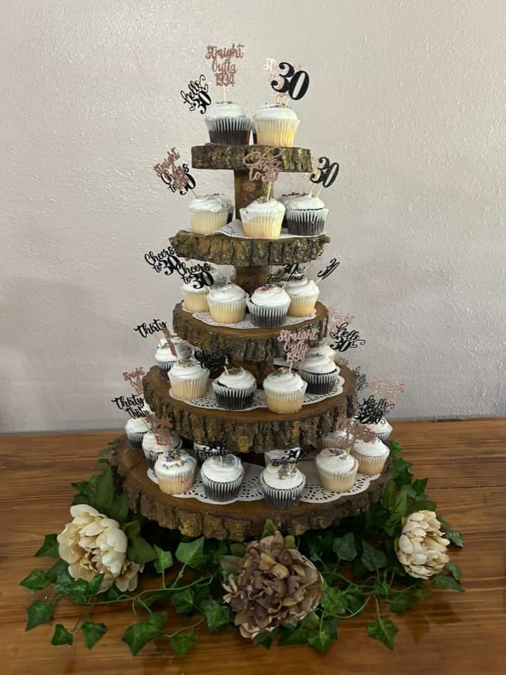 Food buffet with various dishes and drinks on a long table in a room.