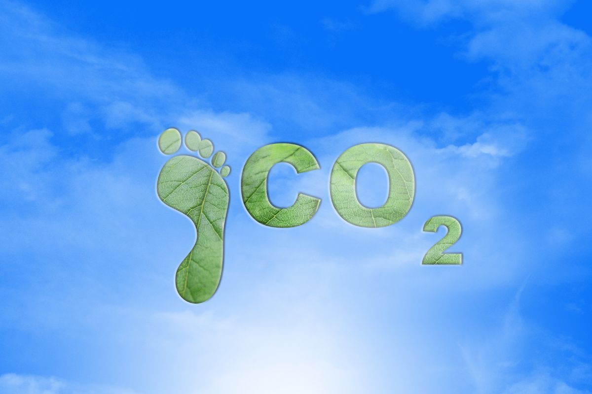 Co2 with footprint symbol on blue sky background