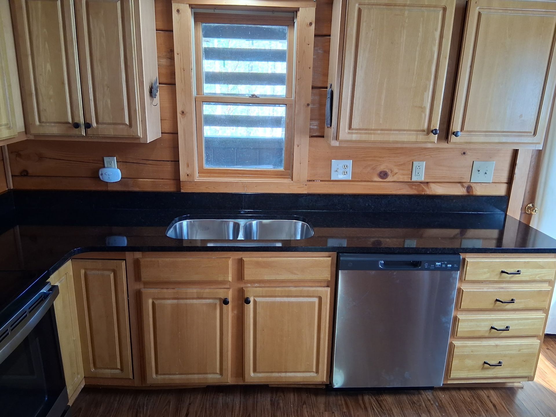 A kitchen with stainless steel appliances and wooden cabinets
