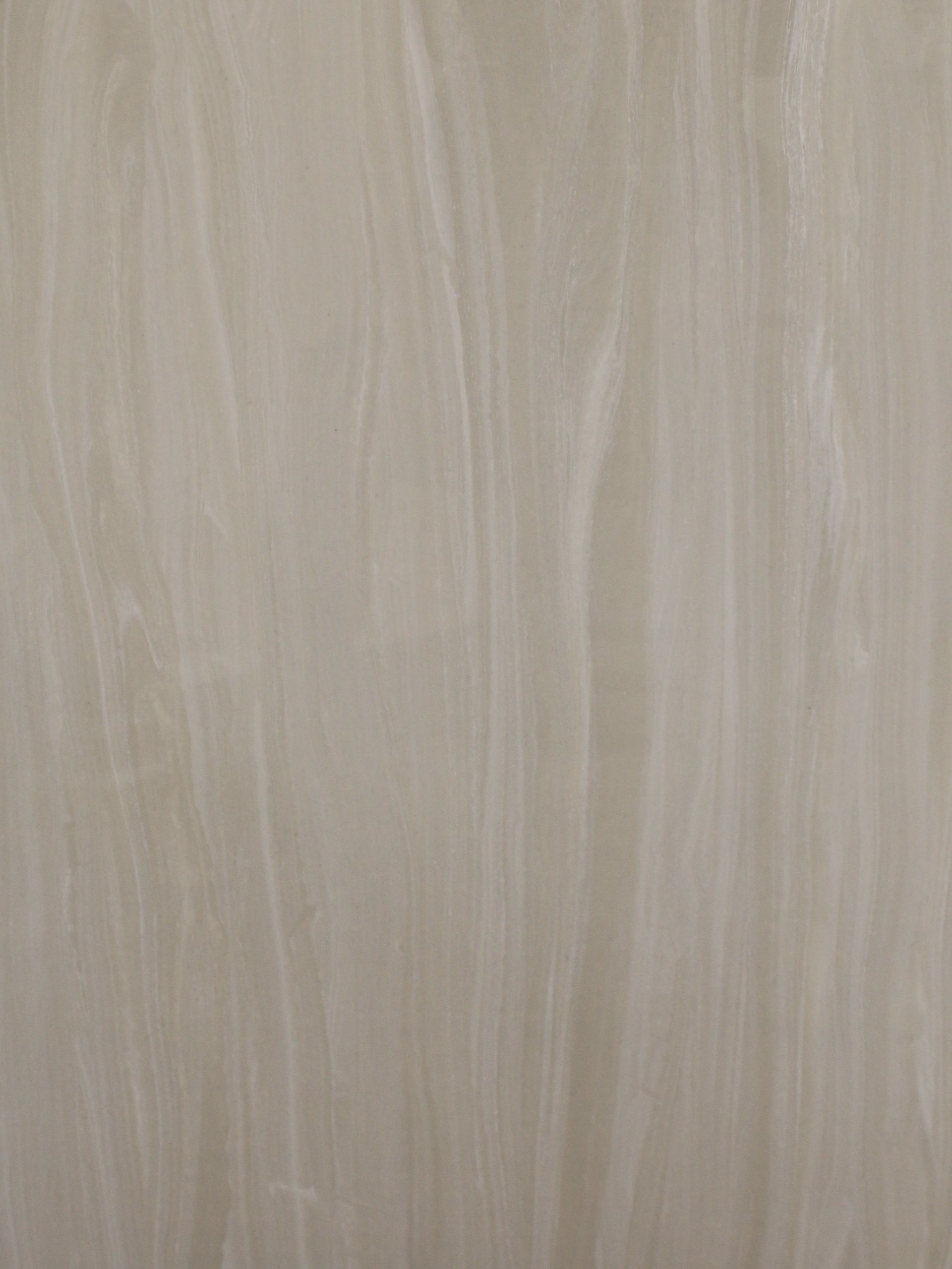 A close up of a white tile with a grainy texture.