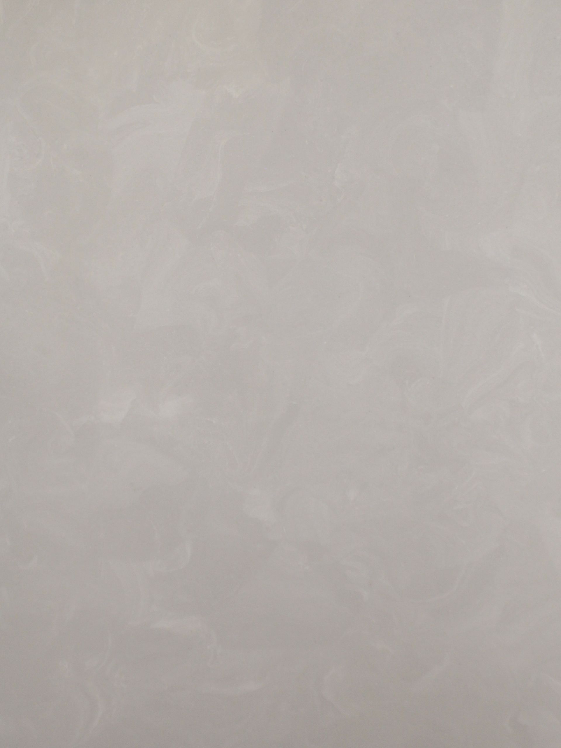 A close up of a white tile with a gray texture.