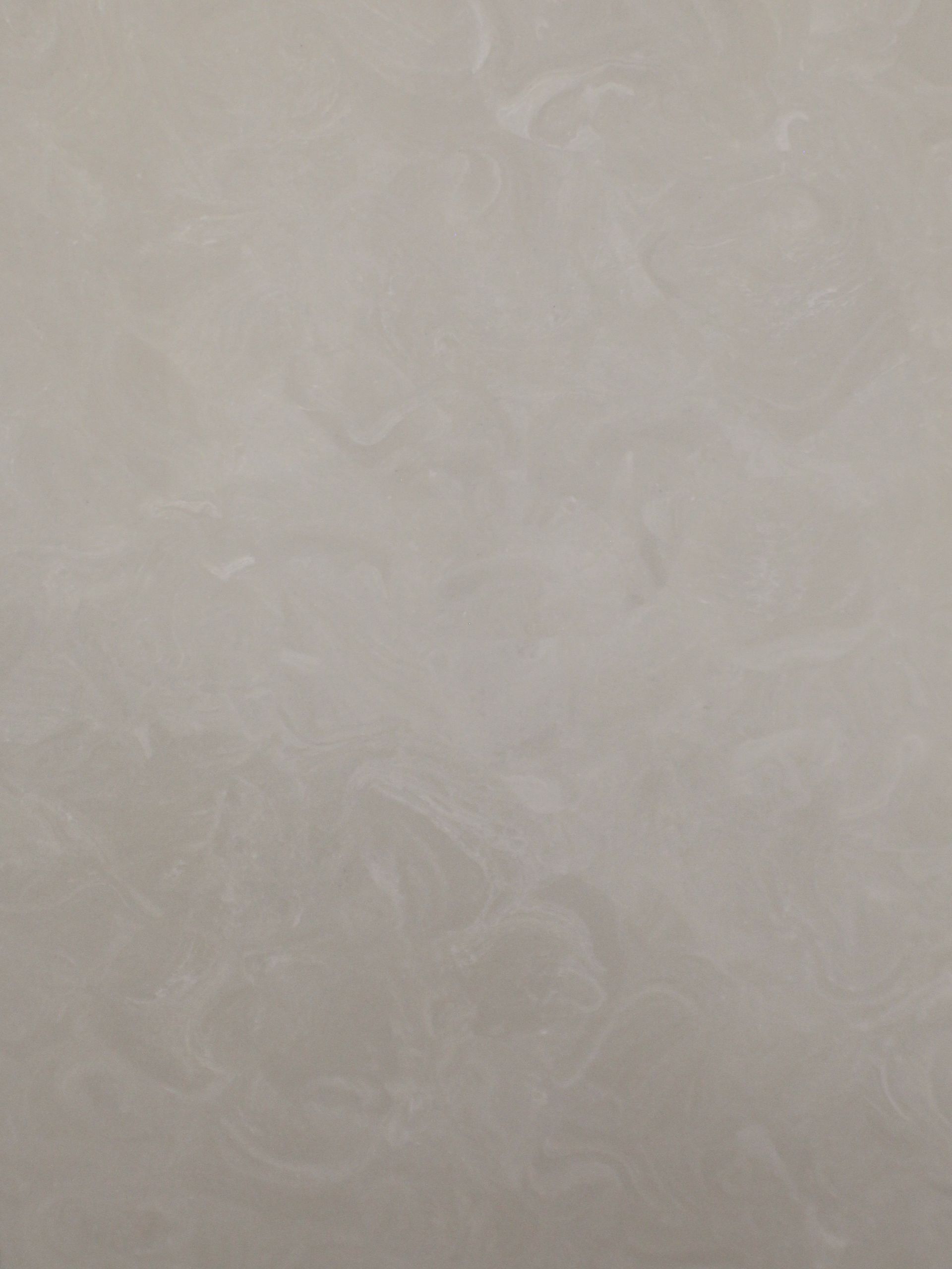 A close up of a white tile with a marble texture.