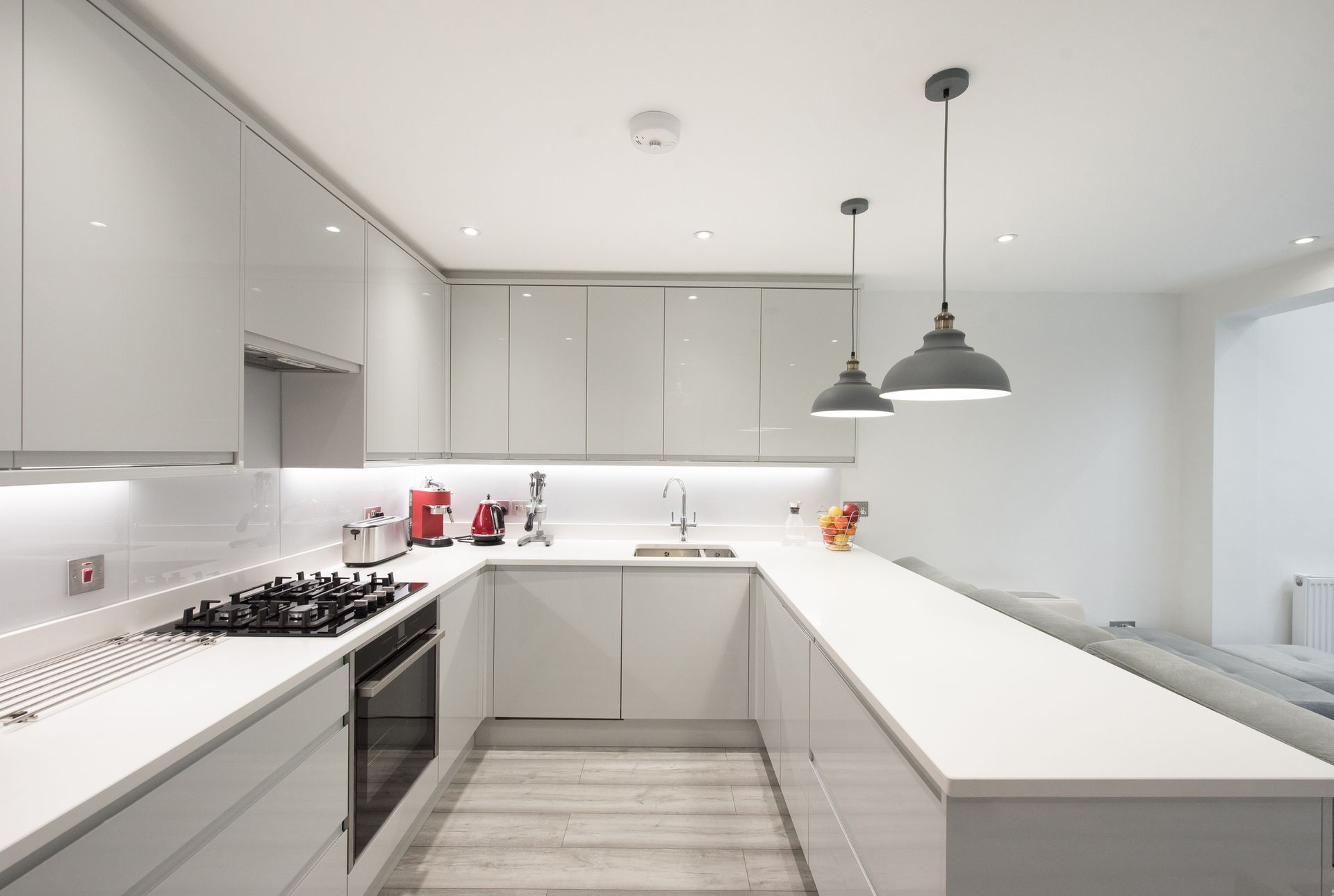 A general interior view of a new kitchen with a white quartz worktop.