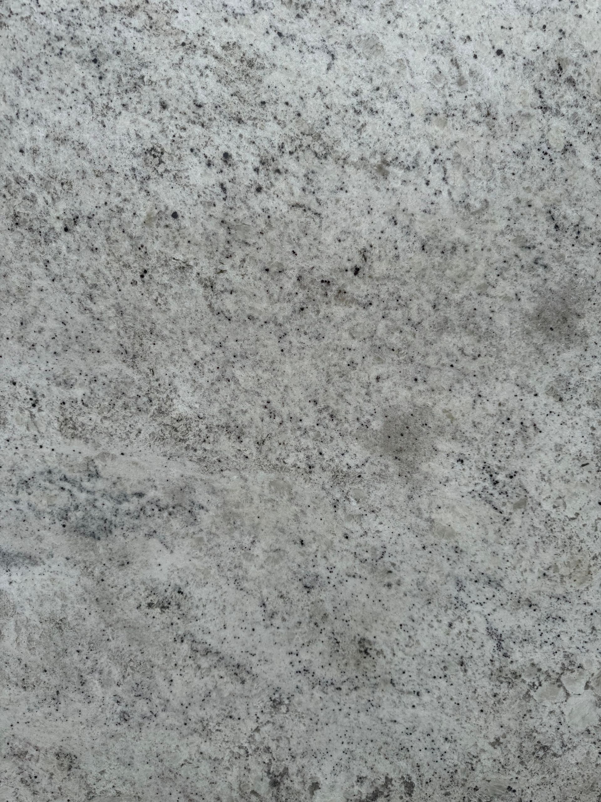 A close up of a white granite counter top.