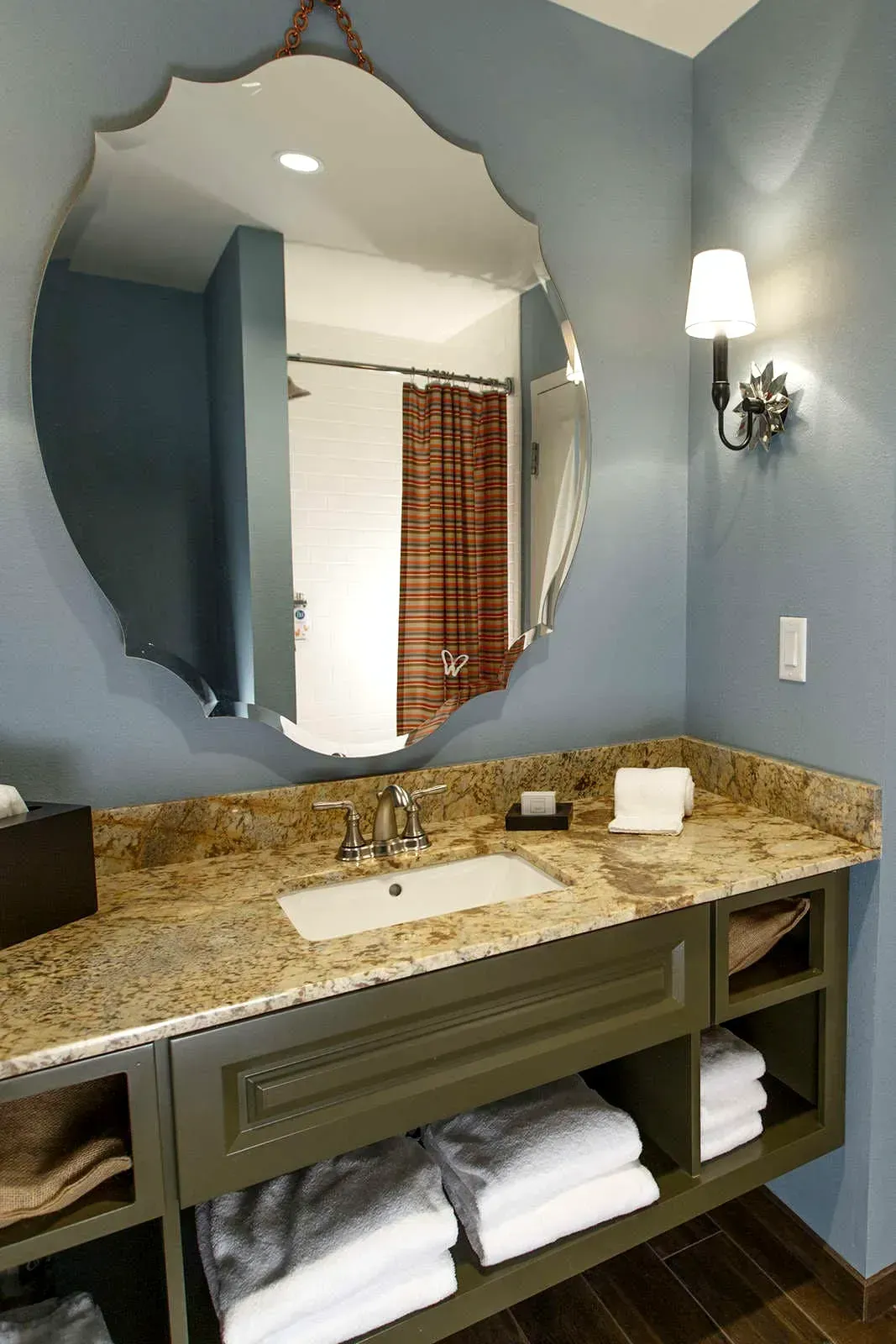 A bathroom with a sink and a large mirror