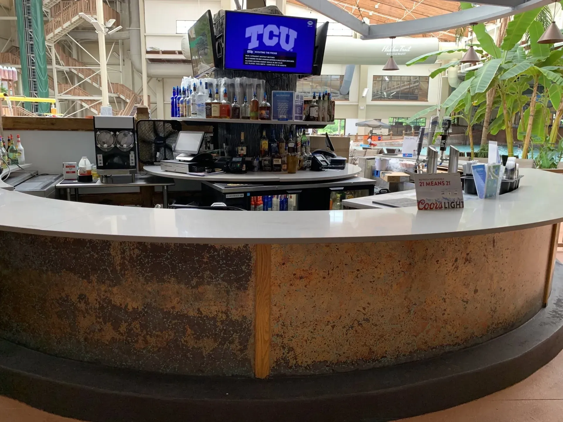 A bar with a tv that says tcu on it