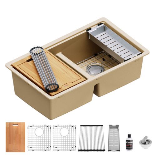 Tan kitchen sink with accessories: cutting board, dish rack, and strainer.