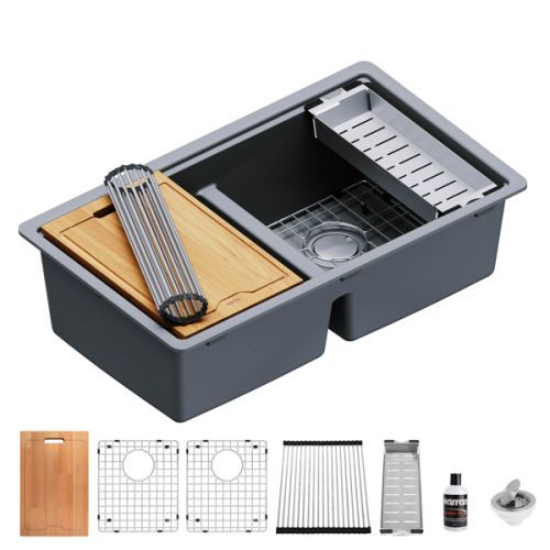 Gray double-basin kitchen sink with accessories: cutting board, dish rack, and drain protector.