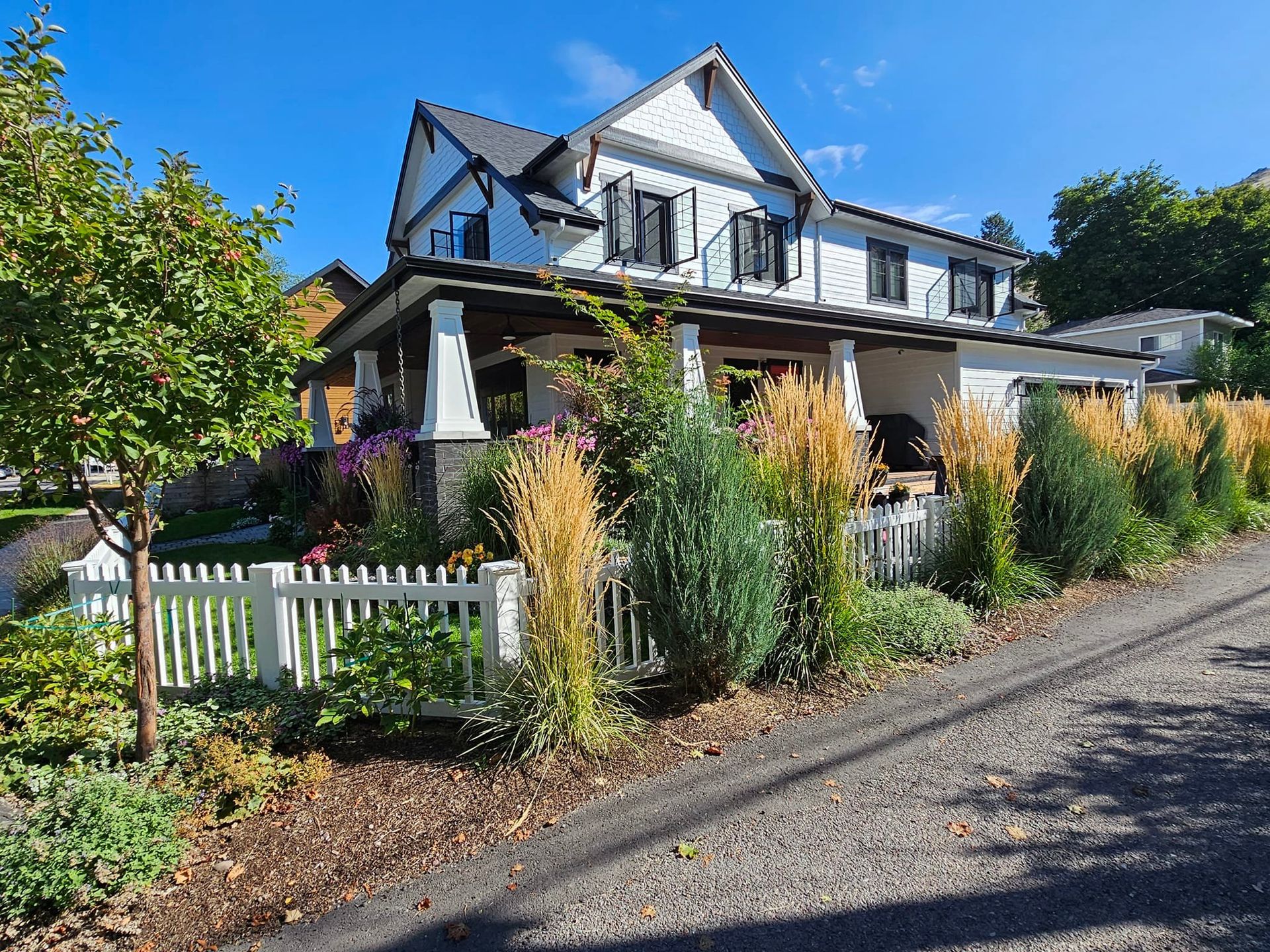 A large white house with a white picket fence in front of it