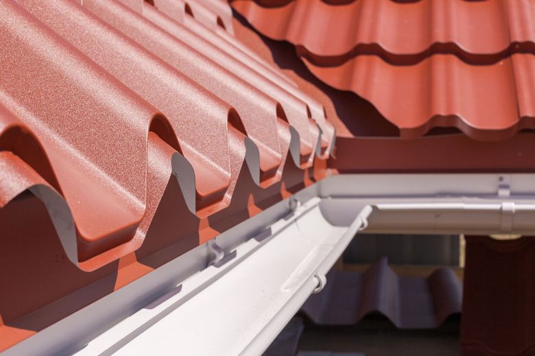 A red roof with a white gutter on it