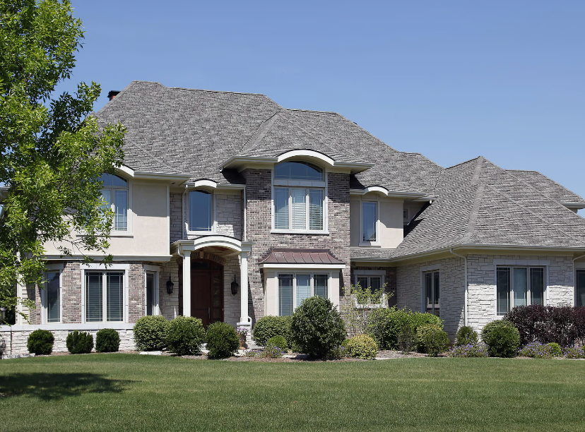 A large house with a large lawn in front of it