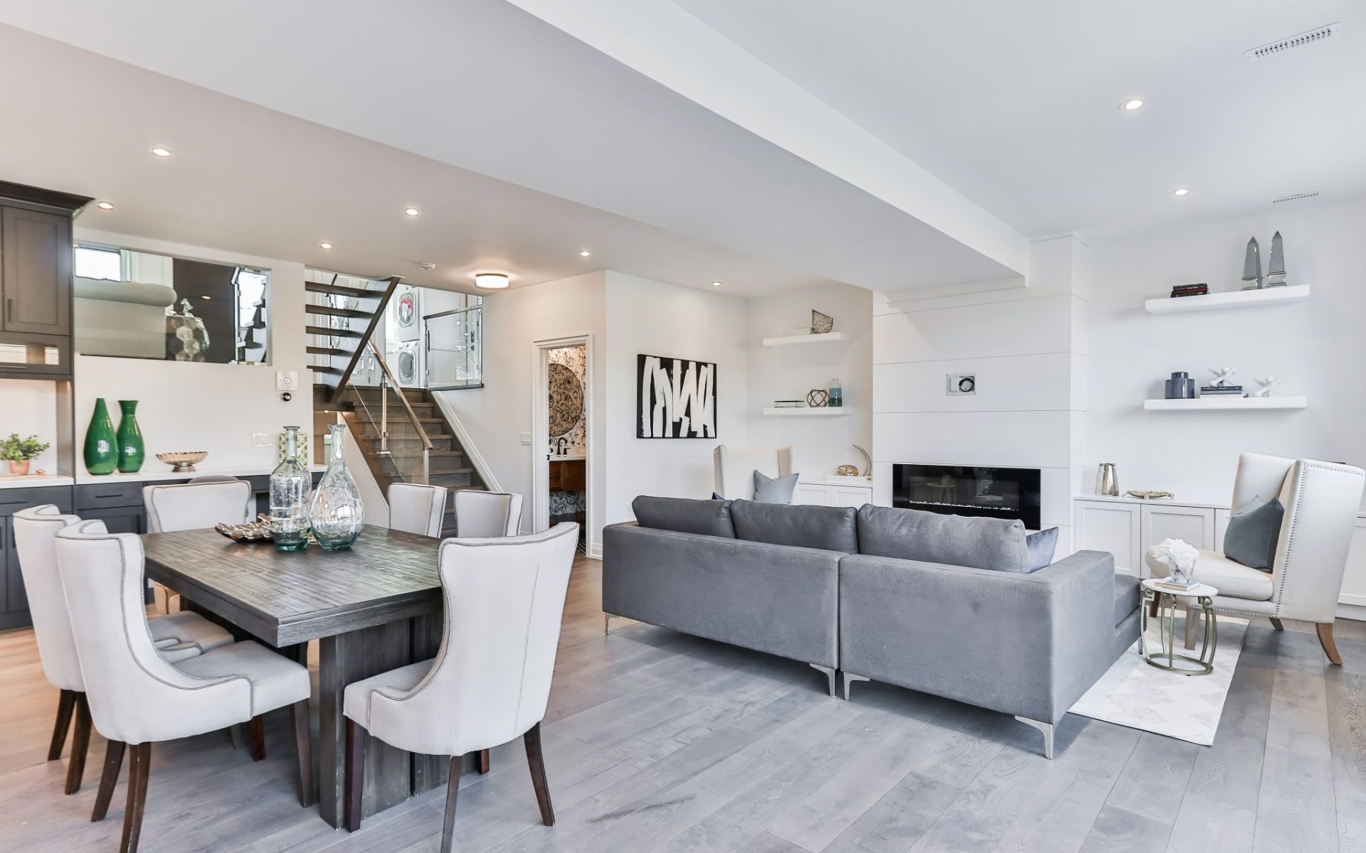 A living room with a couch , table and chairs.