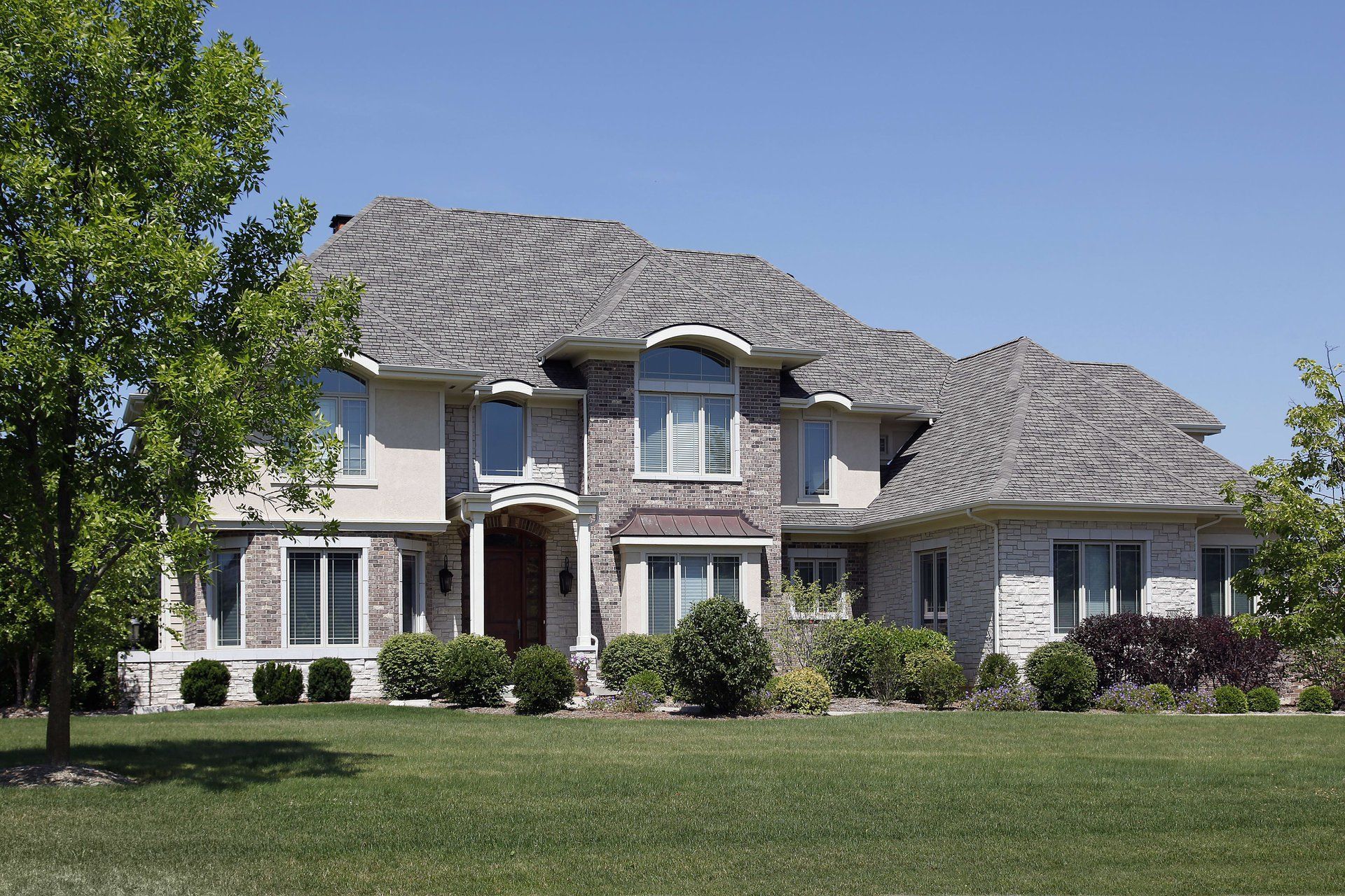 A large house with a large lawn in front of it