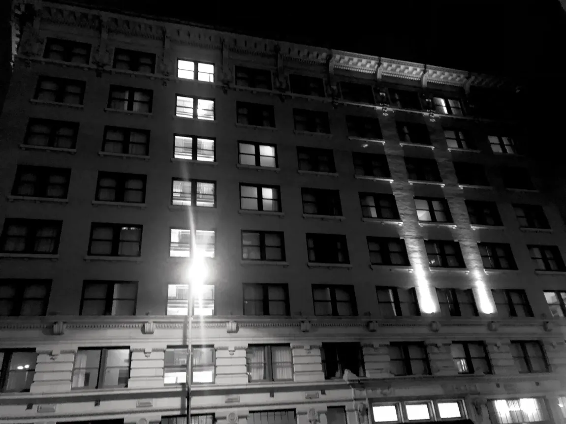 A large building with many windows is lit up at night