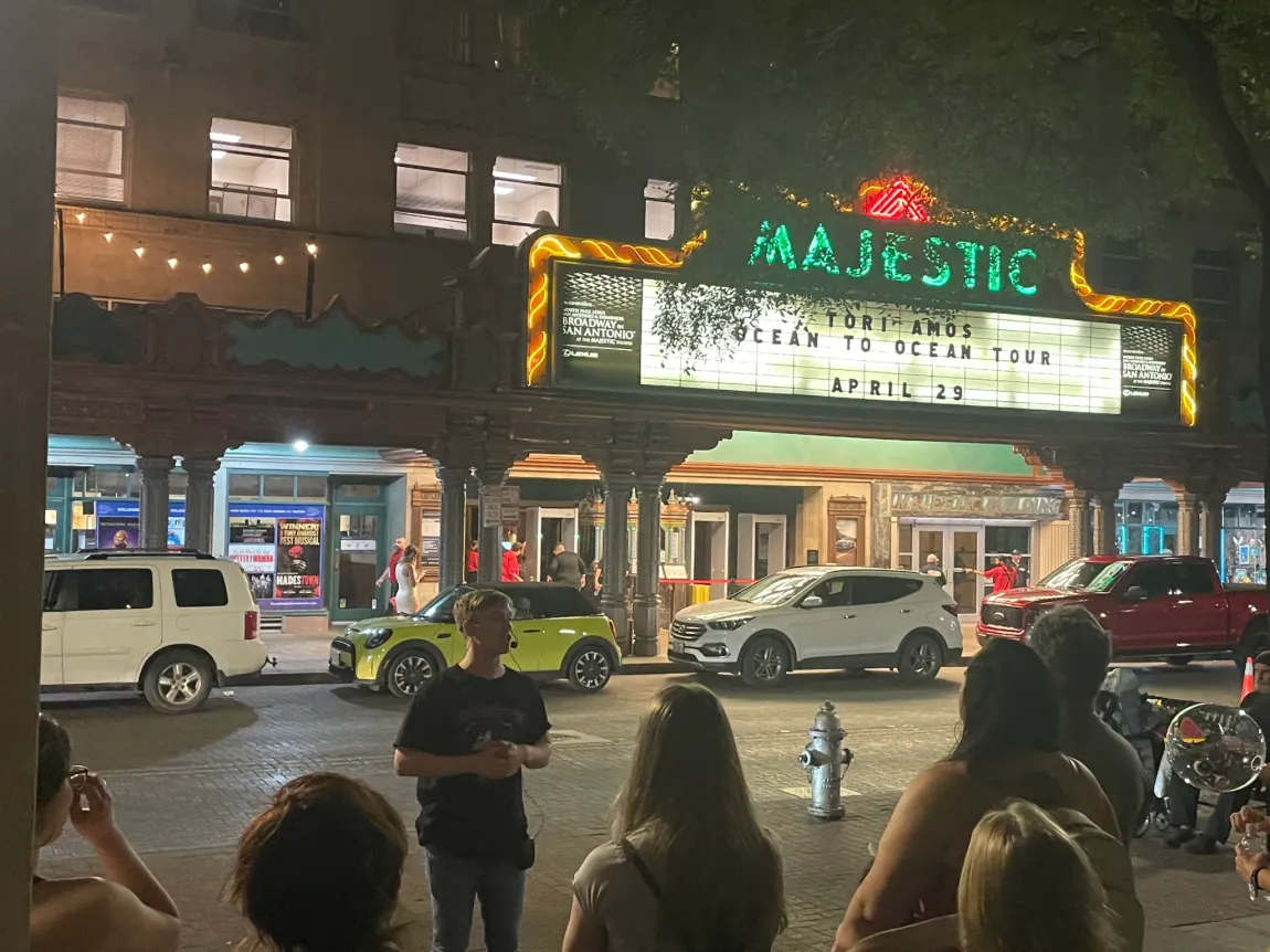 A group of people are standing in front of the majestic theater