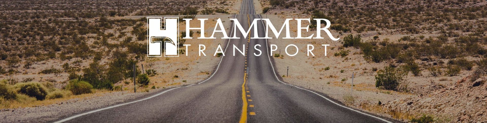 A desert road stretches to the horizon with the Hammer Transport logo at the top.